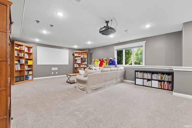 home theater featuring a textured ceiling and light colored carpet