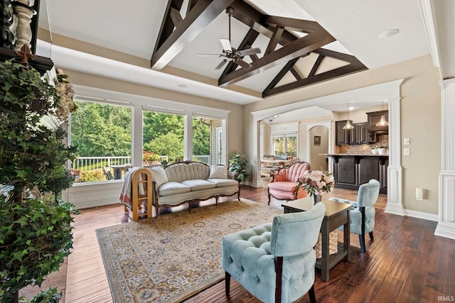 interior space featuring vaulted ceiling with beams and ceiling fan