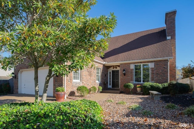 210 Shane Ct, Evansville, IN 47715 - view of front of house with a chimney, an attached garage, brick siding, roof with shingles, and driveway