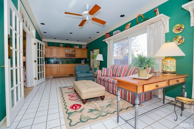 living room with light tile patterned floors, ceiling fan, and crown molding