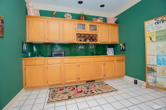 kitchen featuring sink, light tile patterned floors, and crown molding