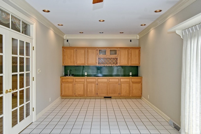 210 Shane Ct, Evansville, IN 47715 - kitchen featuring backsplash, light tile patterned flooring, crown molding, a sink, and baseboards