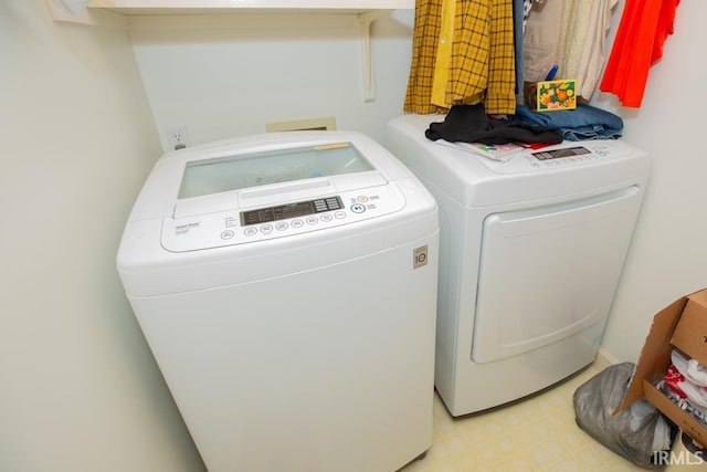 clothes washing area featuring washer and clothes dryer