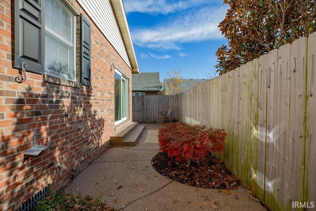 210 Shane Ct, Evansville, IN 47715 - view of side of home with brick siding, a fenced backyard, and a patio