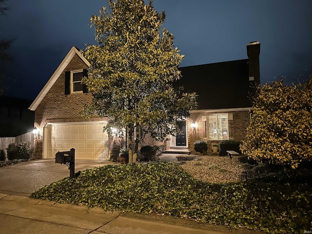 210 Shane Ct, Evansville, IN 47715 - view of front of home featuring brick siding, concrete driveway, and a chimney