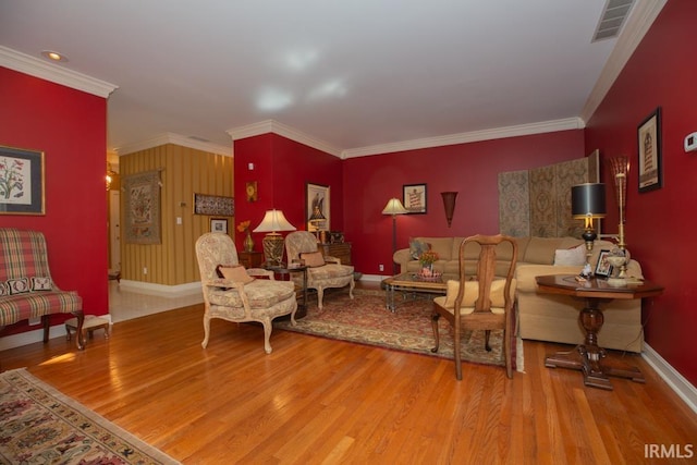 living room with hardwood / wood-style floors and crown molding