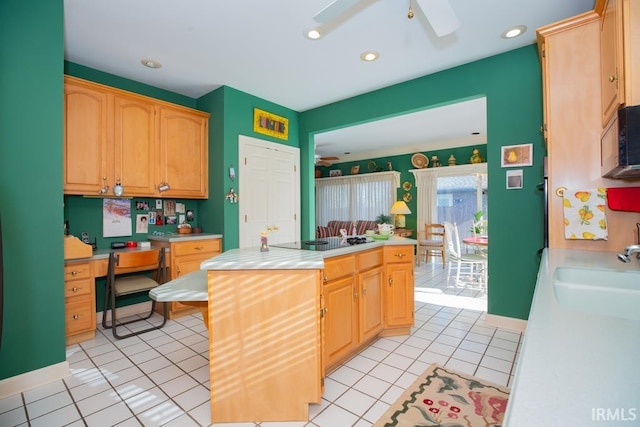 kitchen with black appliances, ceiling fan, light tile patterned flooring, and sink