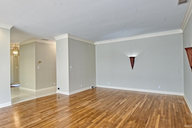 210 Shane Ct, Evansville, IN 47715 - spare room featuring wood finished floors, crown molding, and baseboards