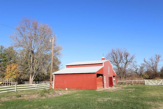 view of outbuilding featuring a yard and a rural view