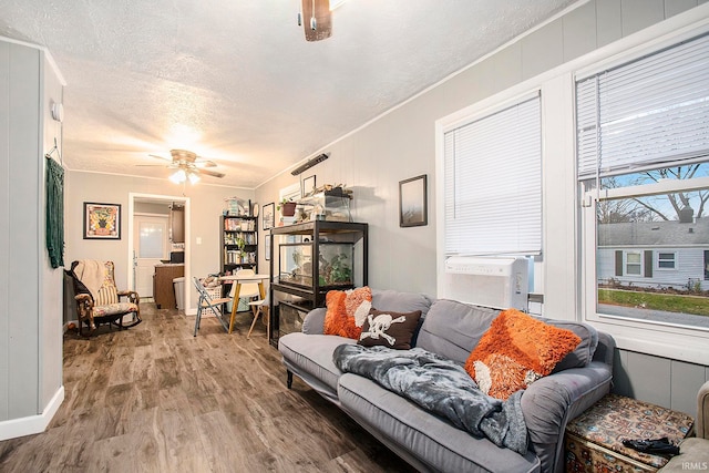 living room featuring plenty of natural light, hardwood / wood-style floors, and a textured ceiling