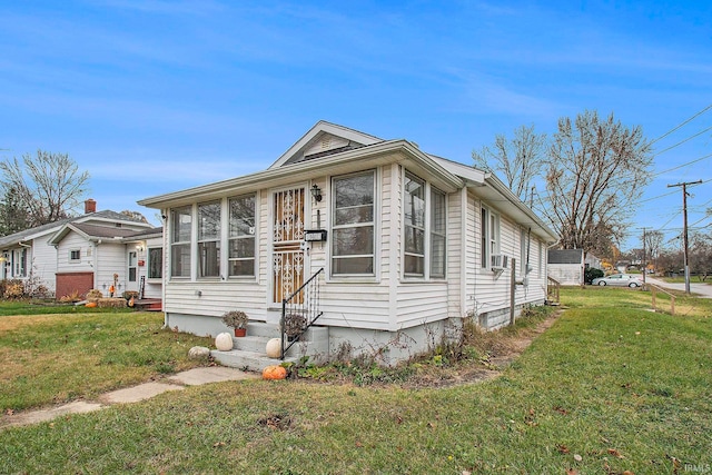 view of front of home with a sunroom, cooling unit, and a front lawn