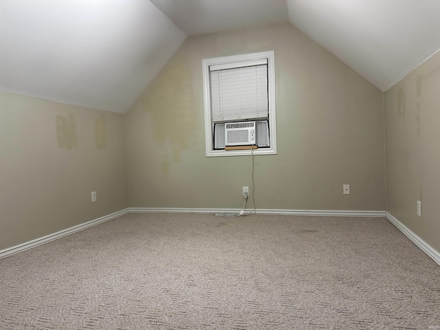 bonus room with cooling unit, lofted ceiling, and carpet floors