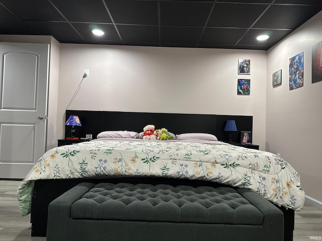 bedroom with hardwood / wood-style flooring and a drop ceiling