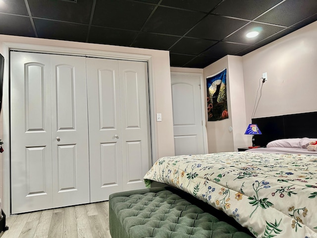 bedroom with hardwood / wood-style floors and a closet