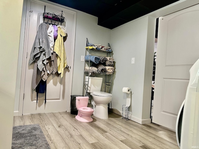 bathroom featuring hardwood / wood-style floors and toilet