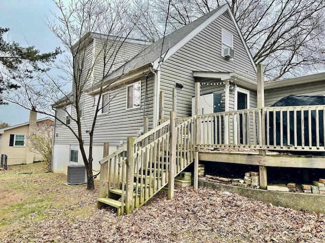 rear view of house with central air condition unit and a wooden deck