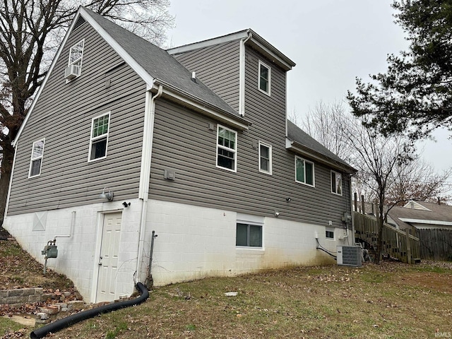 rear view of property with central AC