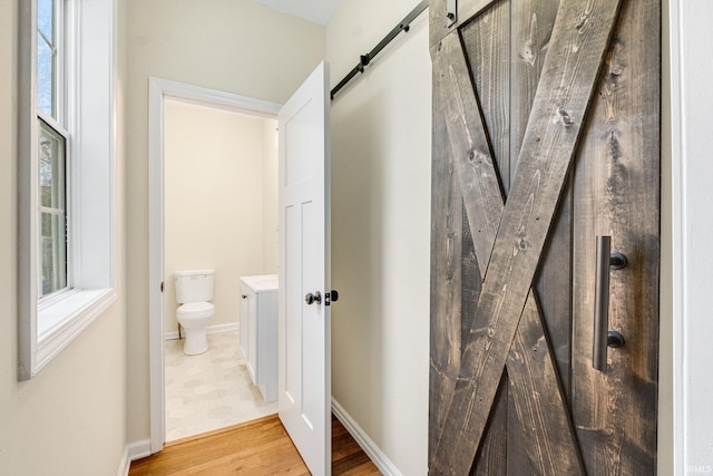 bathroom featuring hardwood / wood-style floors, vanity, and toilet