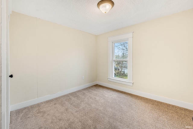 spare room featuring a textured ceiling and carpet floors