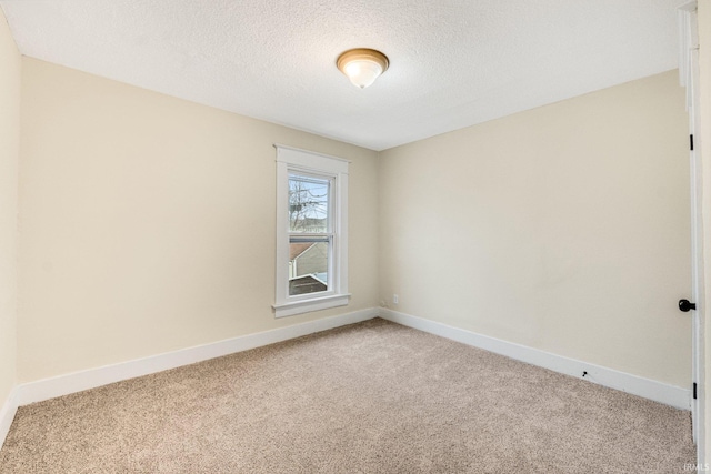 unfurnished room featuring carpet floors and a textured ceiling