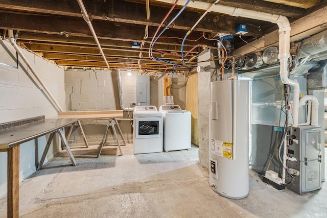 basement with electric panel, water heater, heating unit, and washer and dryer