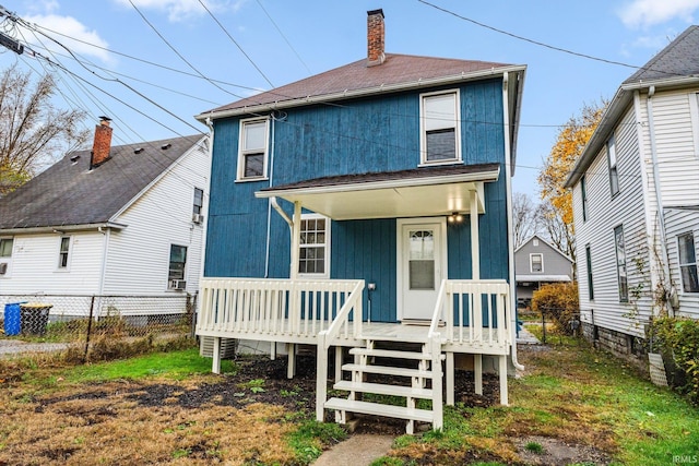 back of property with a porch