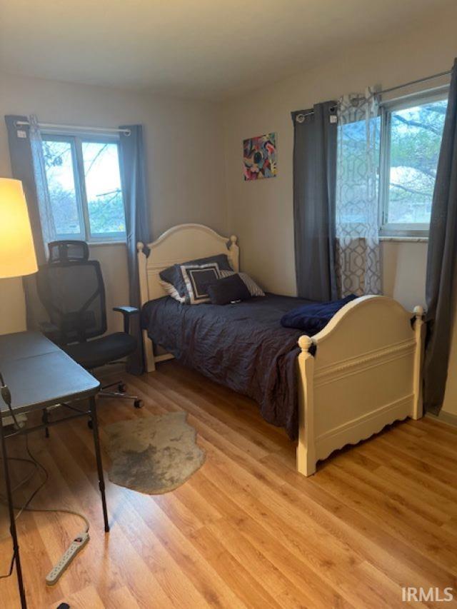 bedroom featuring light hardwood / wood-style floors and multiple windows