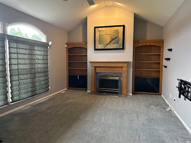 unfurnished living room with carpet floors, ceiling fan, a high end fireplace, and lofted ceiling