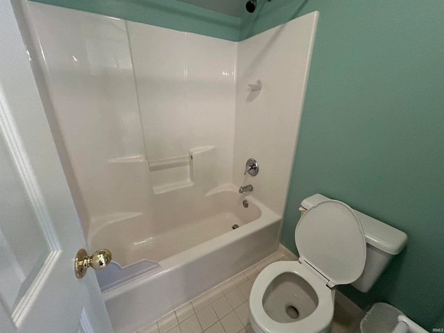 bathroom featuring toilet, shower / bathing tub combination, and tile patterned floors