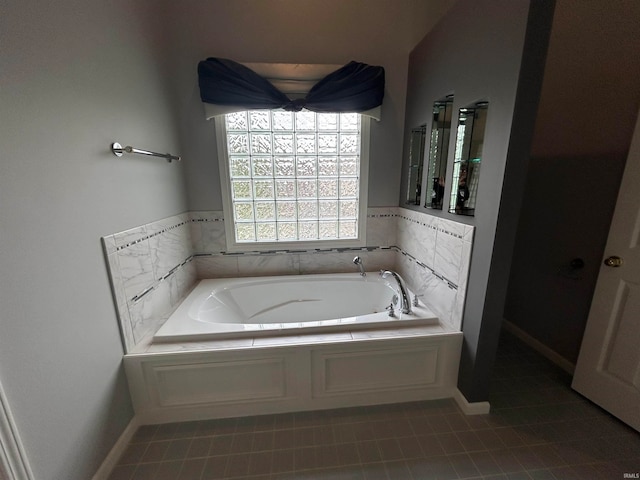 bathroom featuring tile patterned flooring and a bath