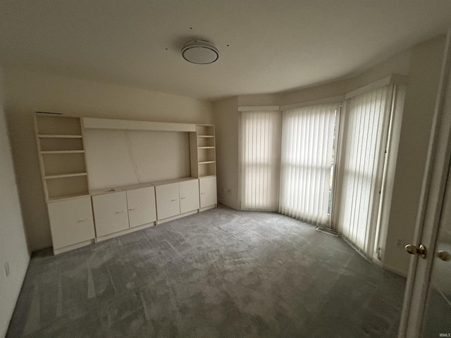 unfurnished bedroom with dark colored carpet