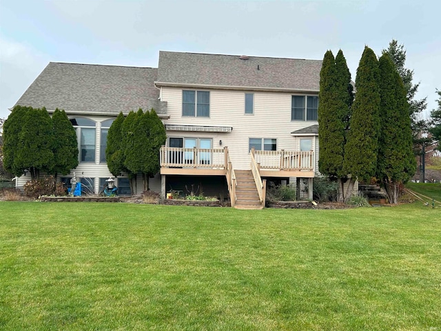 rear view of property with a yard and a wooden deck