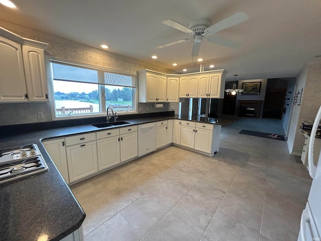 kitchen featuring ceiling fan, dishwasher, sink, stainless steel gas cooktop, and backsplash