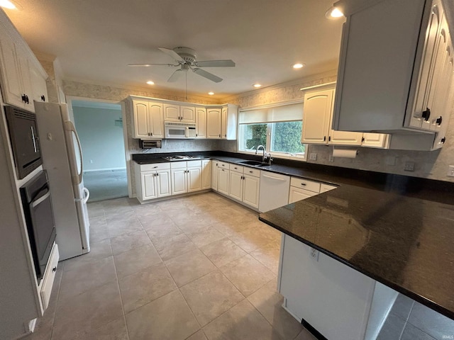 kitchen featuring sink, kitchen peninsula, ceiling fan, white cabinetry, and stainless steel appliances