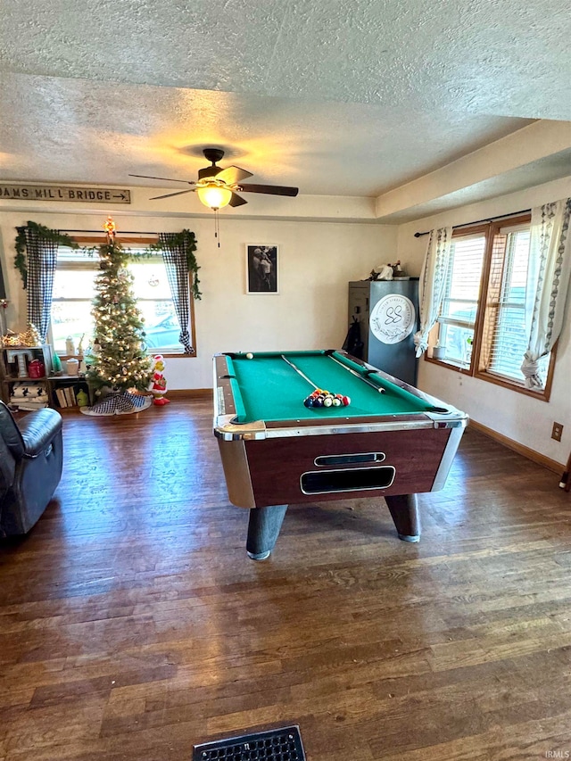 game room with a textured ceiling, dark hardwood / wood-style floors, ceiling fan, and billiards