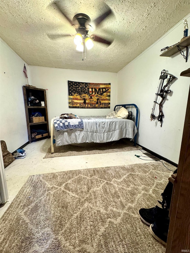 bedroom with a textured ceiling and ceiling fan