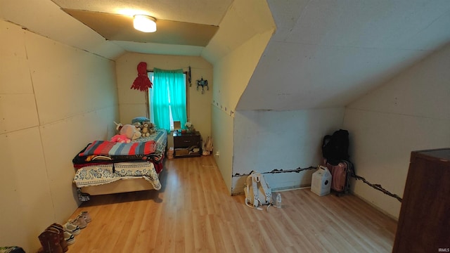 bedroom with lofted ceiling and hardwood / wood-style flooring