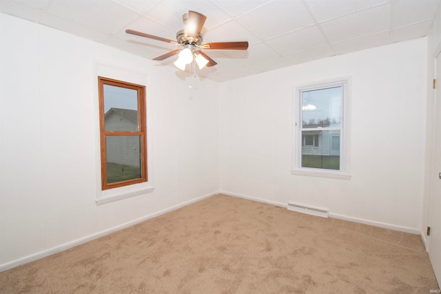 unfurnished room with a wealth of natural light, carpet floors, and ceiling fan