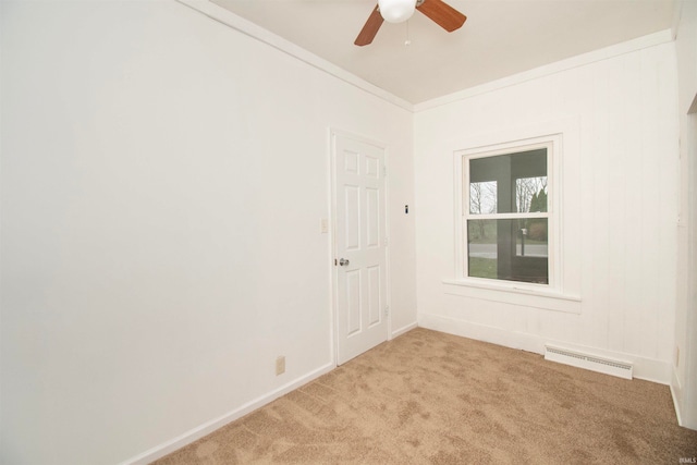 spare room featuring light carpet, ceiling fan, and ornamental molding