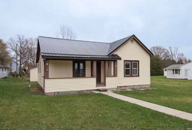 view of front of house with a front yard and a porch