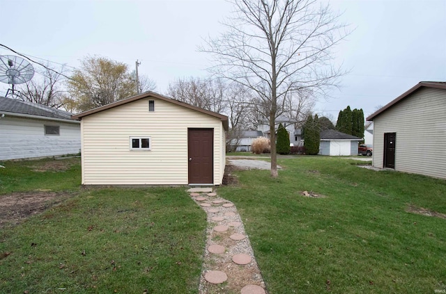 view of outdoor structure featuring a lawn