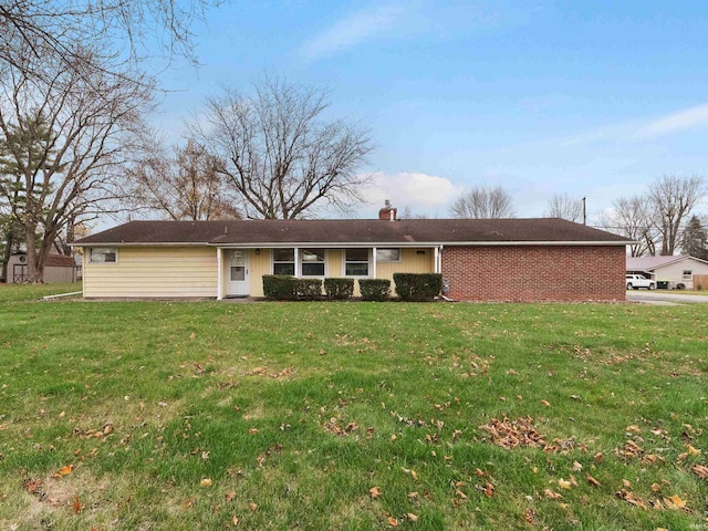 rear view of property featuring a yard