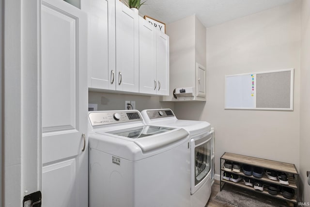 laundry area featuring cabinets, a textured ceiling, and independent washer and dryer