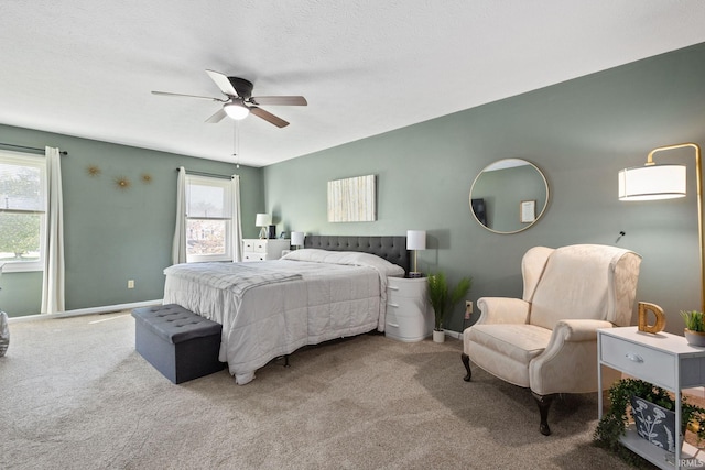 bedroom featuring a textured ceiling, carpet floors, and ceiling fan