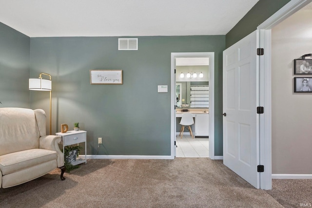 sitting room featuring light colored carpet