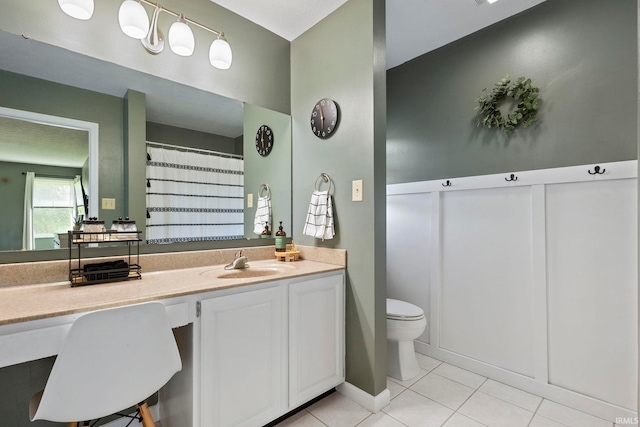 bathroom featuring tile patterned flooring, vanity, and toilet