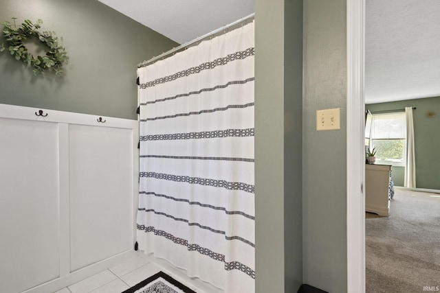 bathroom with tile patterned floors and a textured ceiling