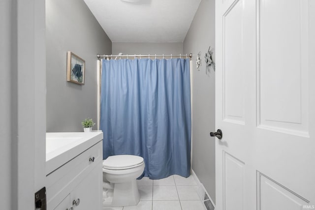 bathroom with a shower with shower curtain, a textured ceiling, vanity, tile patterned flooring, and toilet