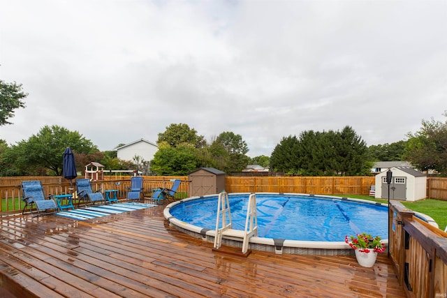 view of swimming pool with a storage unit and a wooden deck