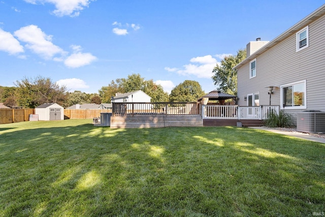 view of yard featuring a gazebo, cooling unit, a shed, and a deck